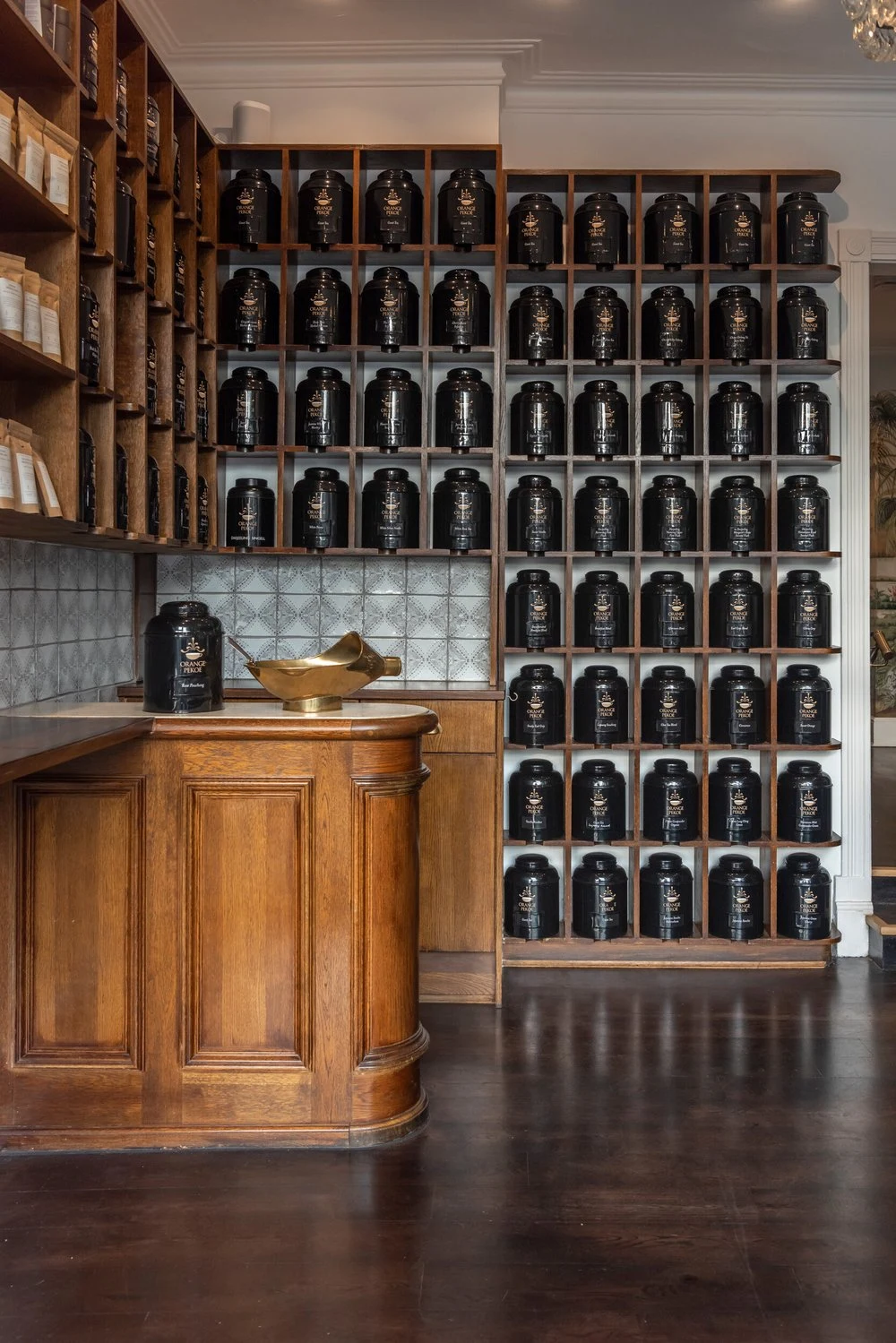 The wall of traditional loose-leaf tea caddies inside Orange Pekoe