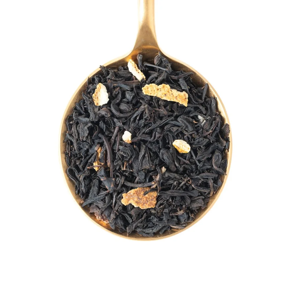 Citrus Grey loose-leaf tea with citrus peel on a tasting spoon