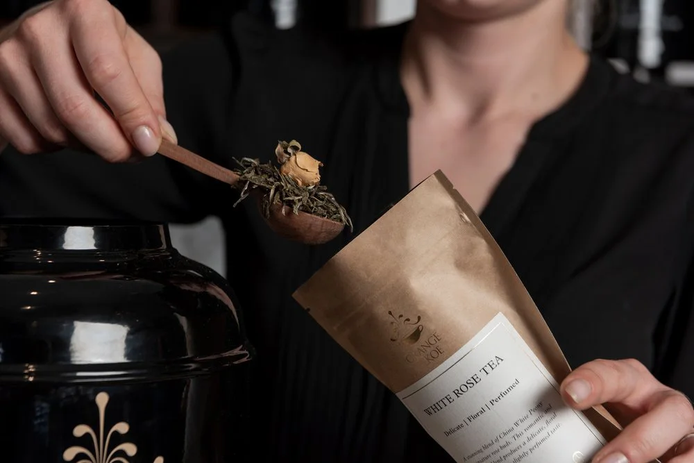 Loose-leaf tea being packed by hand at Orange Pekoe