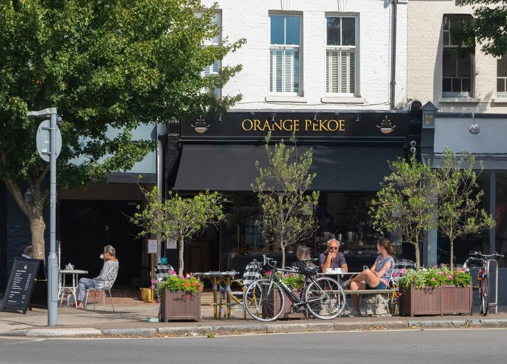 Orange Pekoe's welcoming shopfront and outdoor tables on White Hart Lane